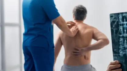 A man with an injured back being examined